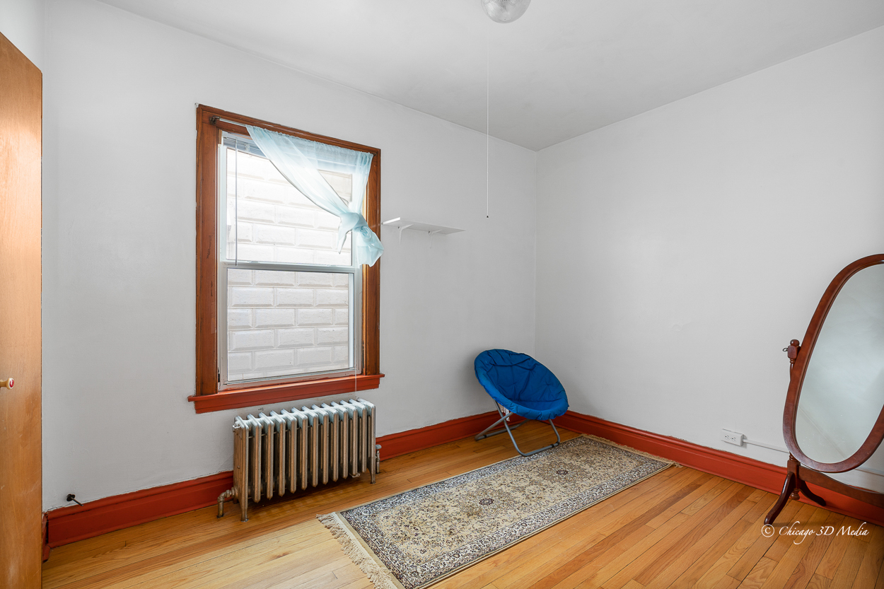 4954 West Byron Street Chicago, IL 60641 - Photo 11 of 42 a view of an empty room with wooden floor and a window
