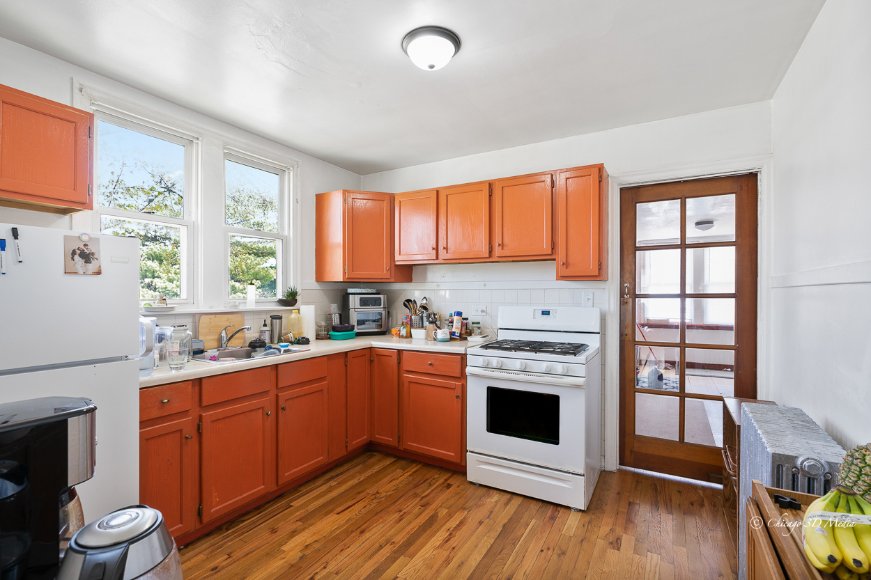 4954 West Byron Street Chicago, IL 60641 - Photo 19 of 42 a kitchen with stainless steel appliances a stove sink and wooden floor