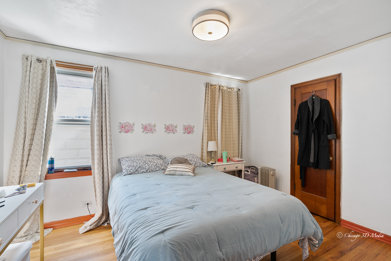 4954 West Byron Street Chicago, IL 60641 - Photo 20 of 42 a bedroom with a bed and a window