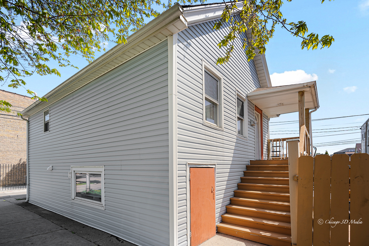 4954 West Byron Street Chicago, IL 60641 - Photo 2 of 42 a view of a house with a door and wooden stairs