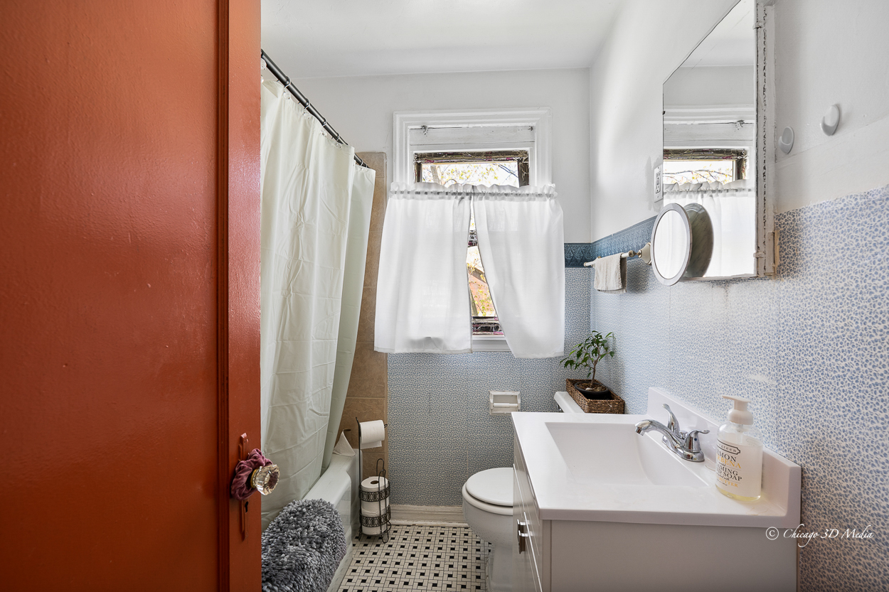 4954 West Byron Street Chicago, IL 60641 - Photo 22 of 42 a bathroom with a sink toilet and shower