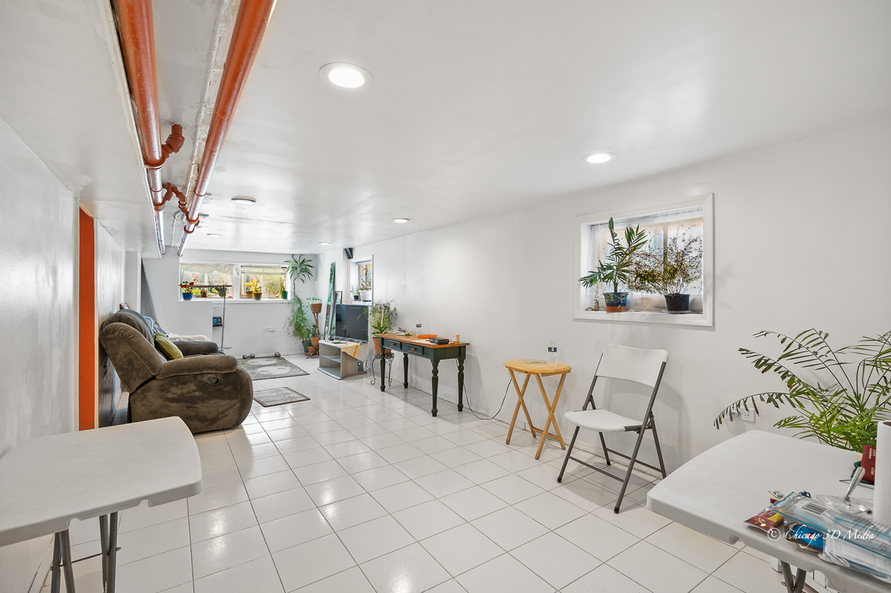 4954 West Byron Street Chicago, IL 60641 - Photo 26 of 42 a living room with furniture and a chandelier