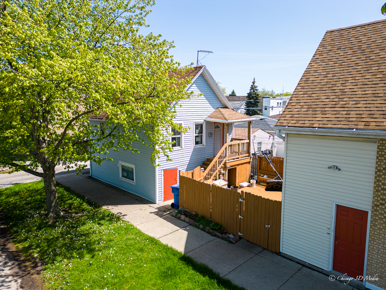 4954 West Byron Street Chicago, IL 60641 - Photo 3 of 42 a view of a house with a backyard