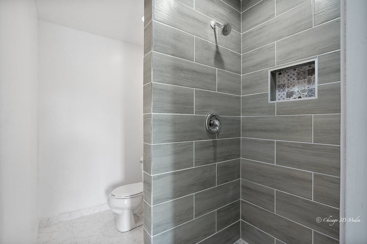 4954 West Byron Street Chicago, IL 60641 - Photo 34 of 42 a bathroom with a toilet and a shower