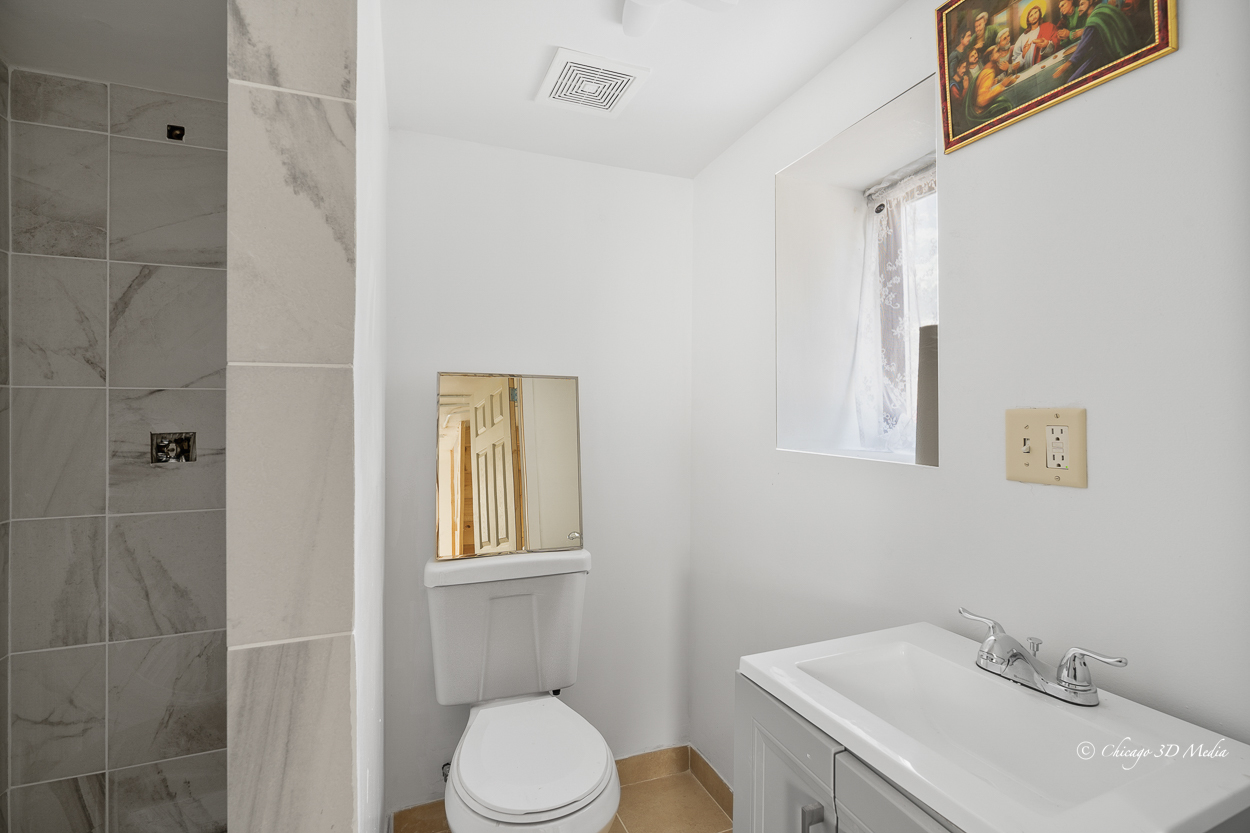 4954 West Byron Street Chicago, IL 60641 - Photo 36 of 42 a bathroom with a sink toilet and shower