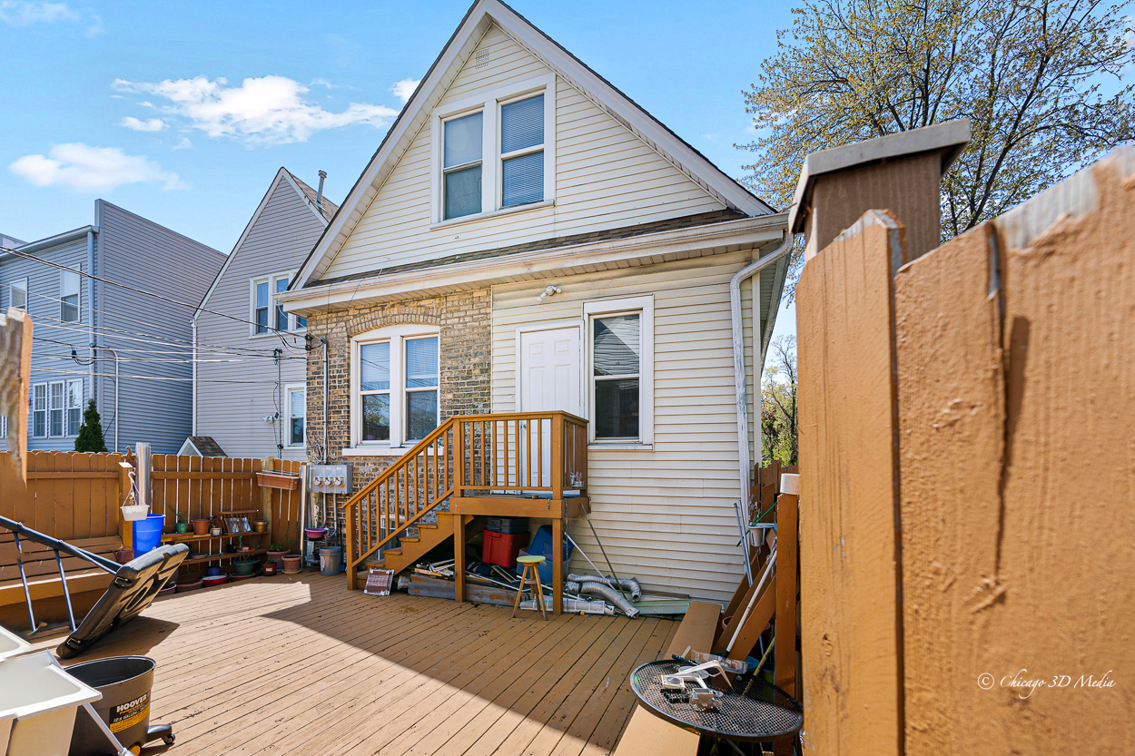 4954 West Byron Street Chicago, IL 60641 - Photo 39 of 42 a view of a house with a patio