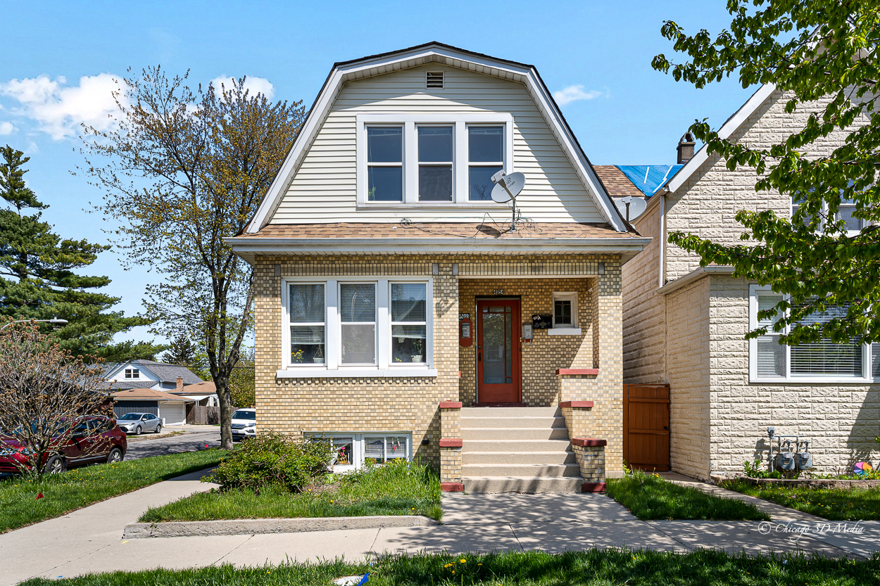 4954 West Byron Street Chicago, IL 60641 - Photo 5 of 42 a front view of a house with a yard
