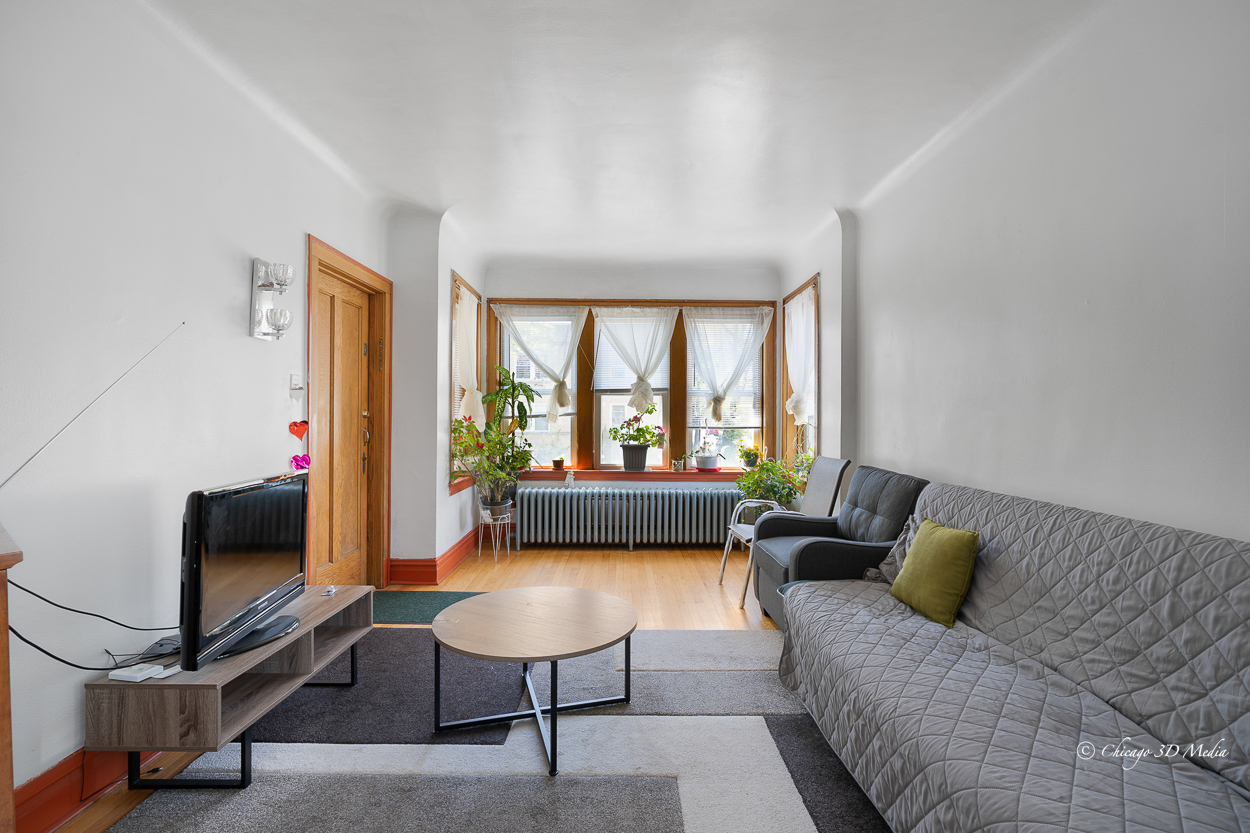 4954 West Byron Street Chicago, IL 60641 - Photo 6 of 42 a living room with furniture a rug and a large window