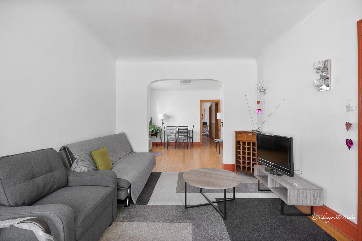 4954 West Byron Street Chicago, IL 60641 - Photo 7 of 42 a living room with furniture and a flat screen tv