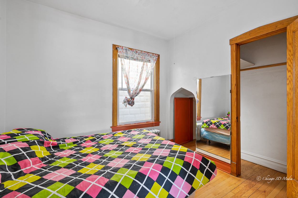 4954 West Byron Street Chicago, IL 60641 - Photo 10 of 42 a bedroom with a bed and a dresser in it