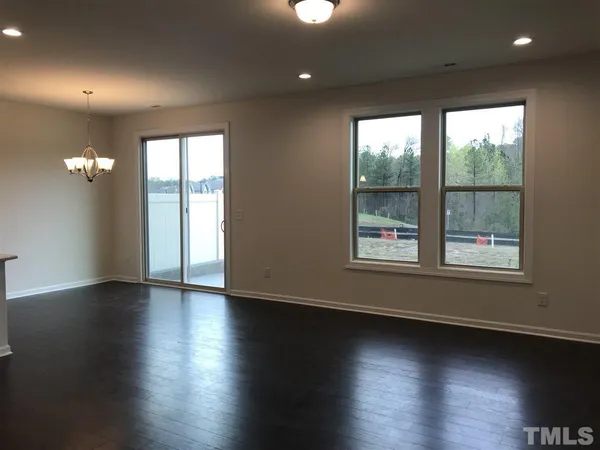 a view of room with window and wooden floor