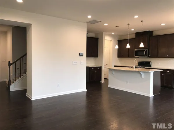 a view of kitchen with stainless steel appliances granite countertop a sink and a stove top oven