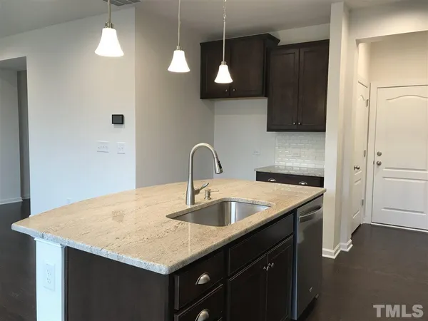 a kitchen with a sink a counter space and cabinets