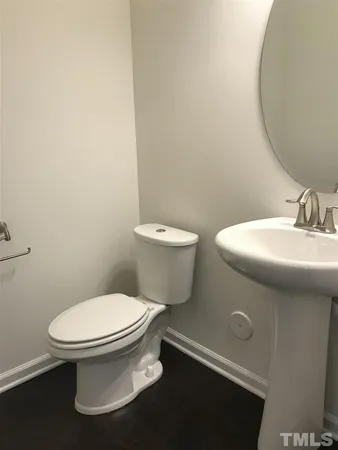 a white toilet sitting next to a bathroom sink