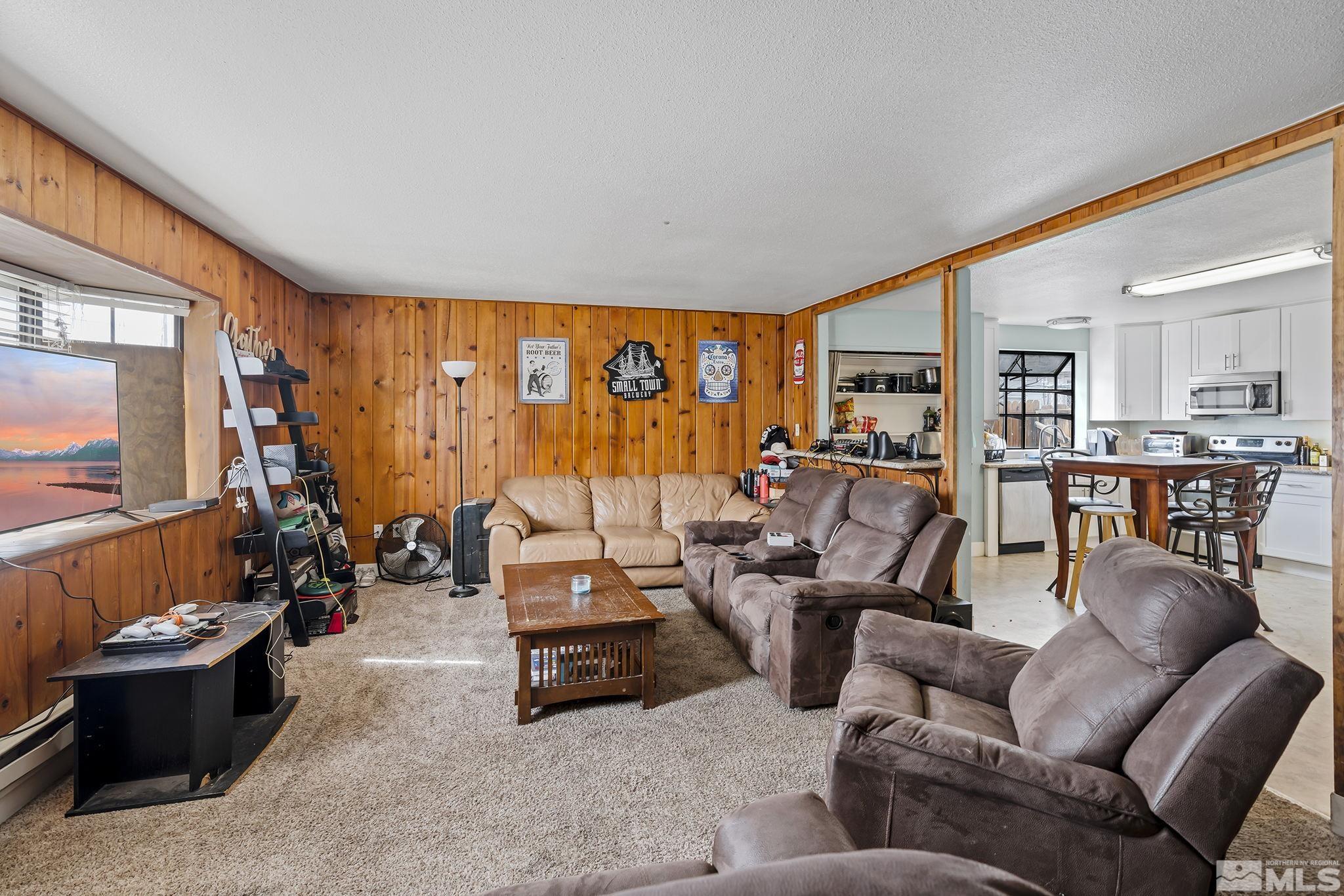 1001 Nevada Street Reno, NV 89503 - Photo 3 of 16 a living room with furniture and a flat screen tv