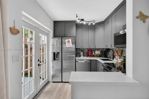 a kitchen with refrigerator and cabinets