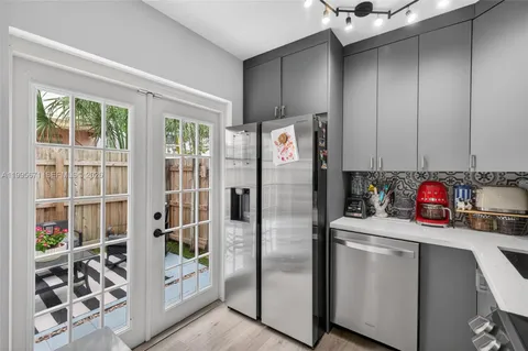 a kitchen with a refrigerator and a sink