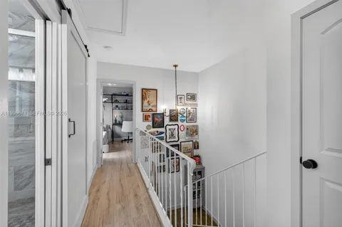 a view of a hallway with windows and stairs
