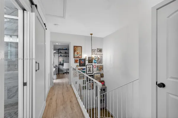 a view of a hallway with windows and stairs