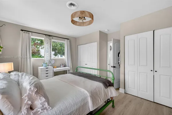 a bedroom with a large bed and a large window