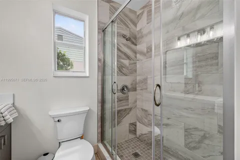 a bathroom with a toilet and shower
