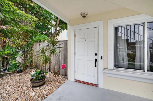 a potted plant sitting in front of a house