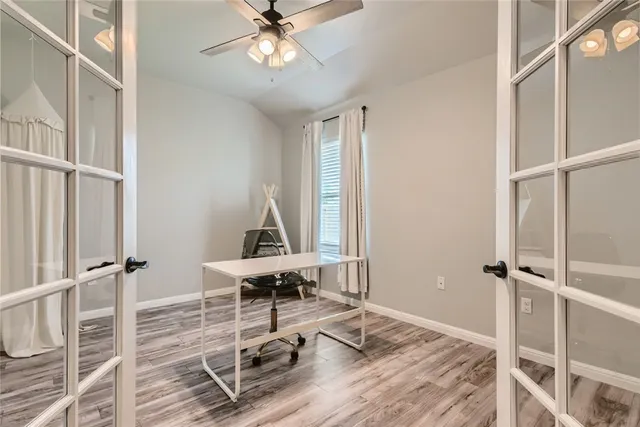 a view of a workspace with wooden floor