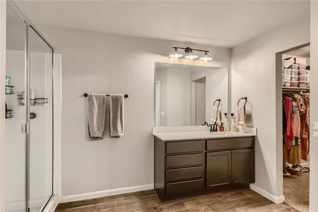 a bathroom with a sink vanity and a mirror