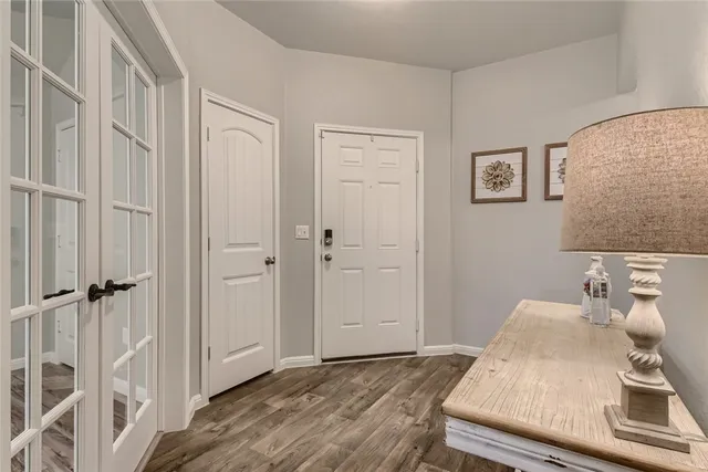 a view of a bedroom with wooden floor