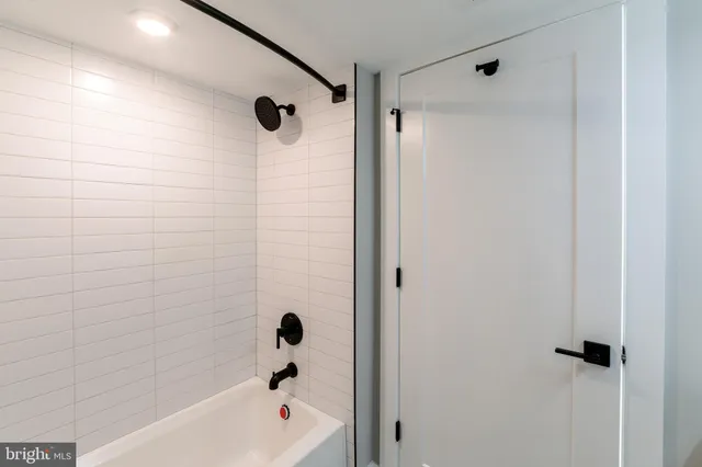 a bathroom with a shower and a bath tub