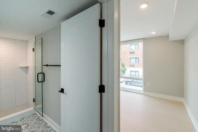 a view of a bathroom with a shower and a sink