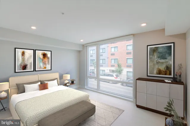 a bedroom with a large bed and a large window