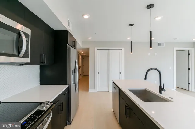 a kitchen with a refrigerator and a sink