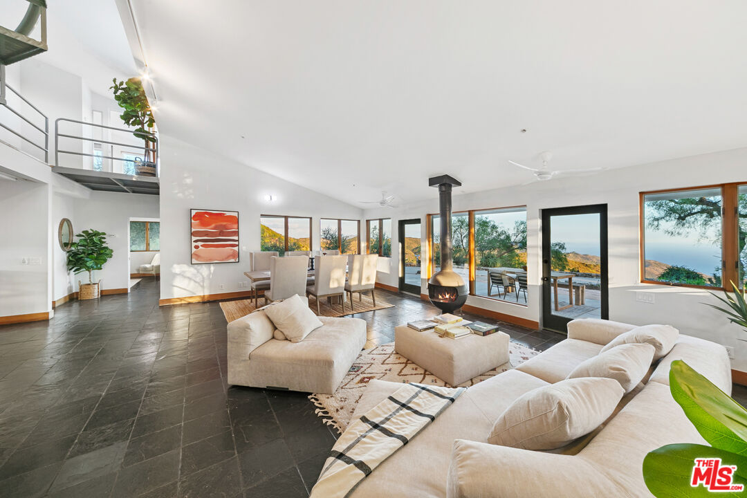 1888 Latigo Canyon Road Malibu, CA 90265 - Photo 1 of 1 a living room with furniture and a large window