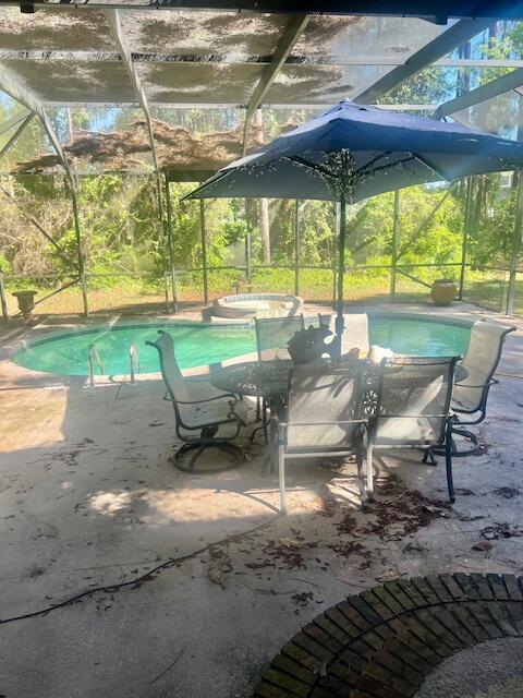 782 Driftwood Point Road Santa Rosa Beach, FL 32459 - Photo 25 of 33 a view of a patio with a table and chairs under an umbrella