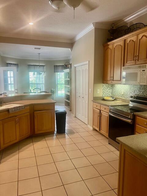782 Driftwood Point Road Santa Rosa Beach, FL 32459 - Photo 8 of 33 a kitchen with stainless steel appliances granite countertop a sink and cabinets