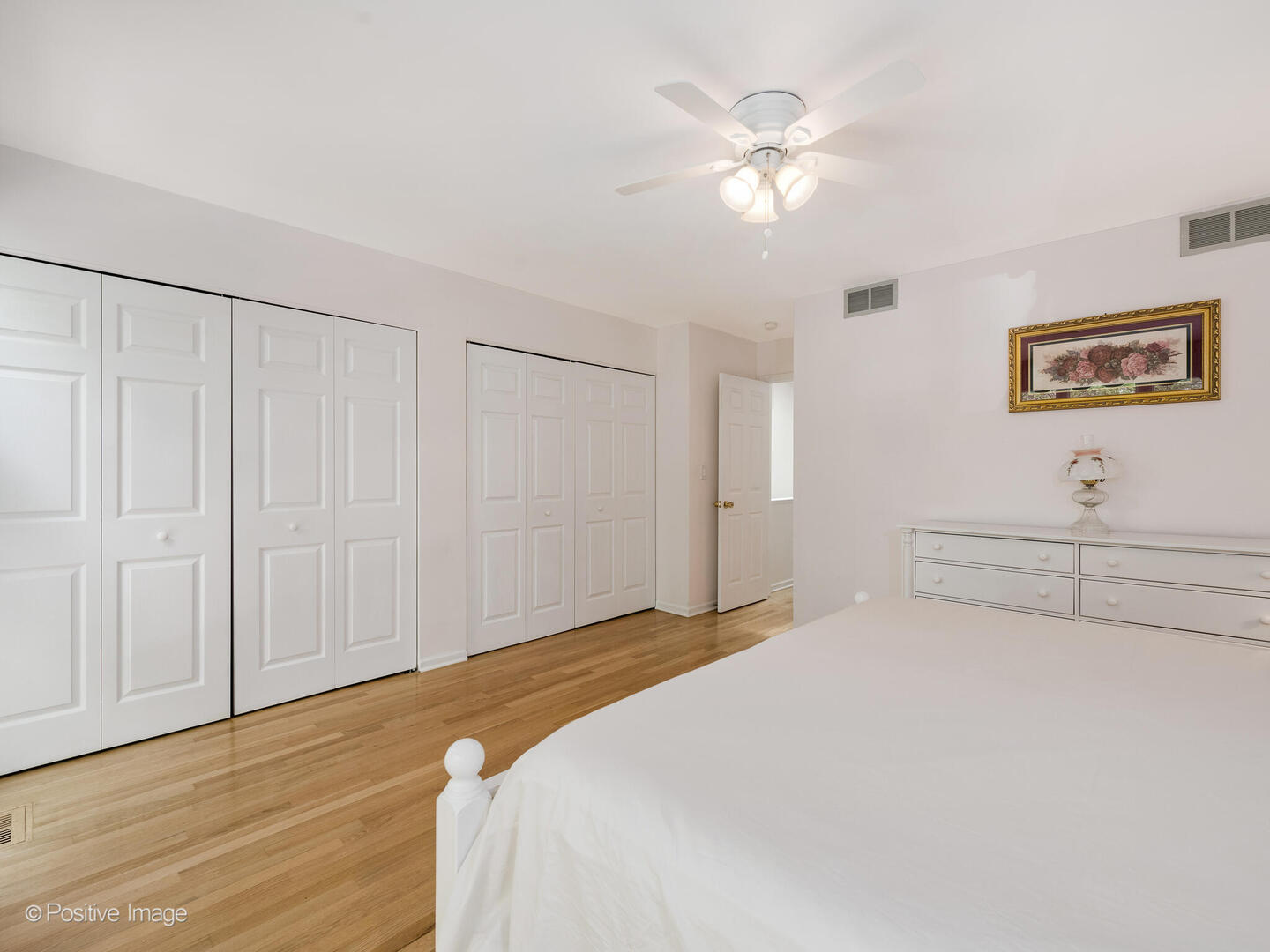 2393 North Wayne Avenue Chicago, IL 60614 - Photo 14 of 24 a bedroom with a large bed and a chandelier