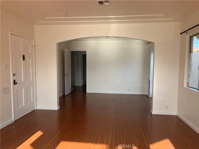 a view of a big room with wooden floor and closet