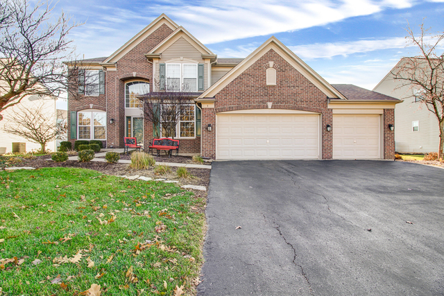 3 Firethorn Court Bolingbrook, IL 60490 - Photo 2 of 39 a front view of a house with a yard and garage