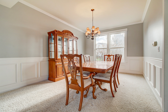 3 Firethorn Court Bolingbrook, IL 60490 - Photo 14 of 39 a view of a dining room with furniture and chandelier