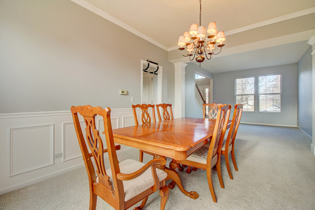 3 Firethorn Court Bolingbrook, IL 60490 - Photo 15 of 39 a dining room with furniture and chandelier