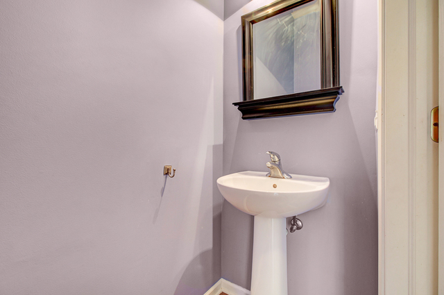 3 Firethorn Court Bolingbrook, IL 60490 - Photo 18 of 39 a bathroom with a sink and a mirror