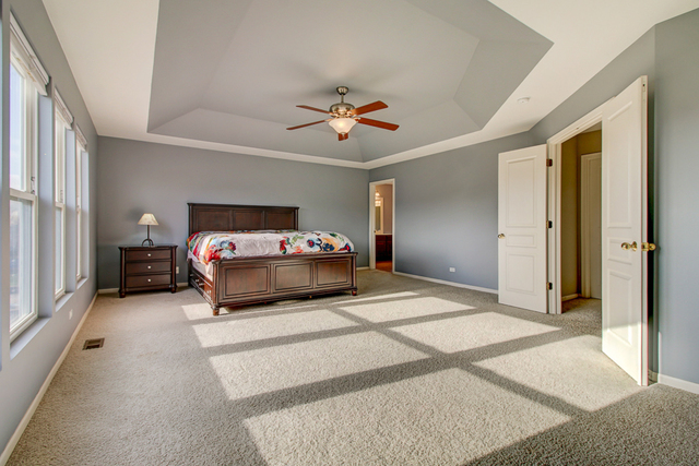 3 Firethorn Court Bolingbrook, IL 60490 - Photo 23 of 39 a living room with furniture and a chandelier
