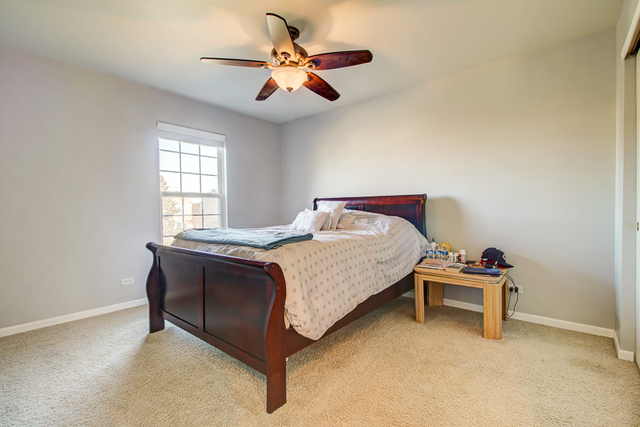 3 Firethorn Court Bolingbrook, IL 60490 - Photo 29 of 39 a bedroom with a bed and a ceiling fan