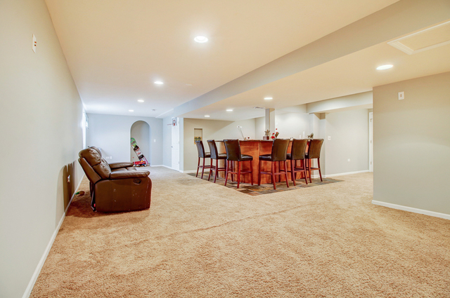 3 Firethorn Court Bolingbrook, IL 60490 - Photo 32 of 39 a living room with furniture and a dining table with kitchen view