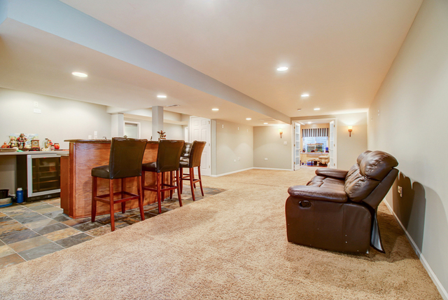 3 Firethorn Court Bolingbrook, IL 60490 - Photo 34 of 39 a living room with furniture and a dining table with kitchen view