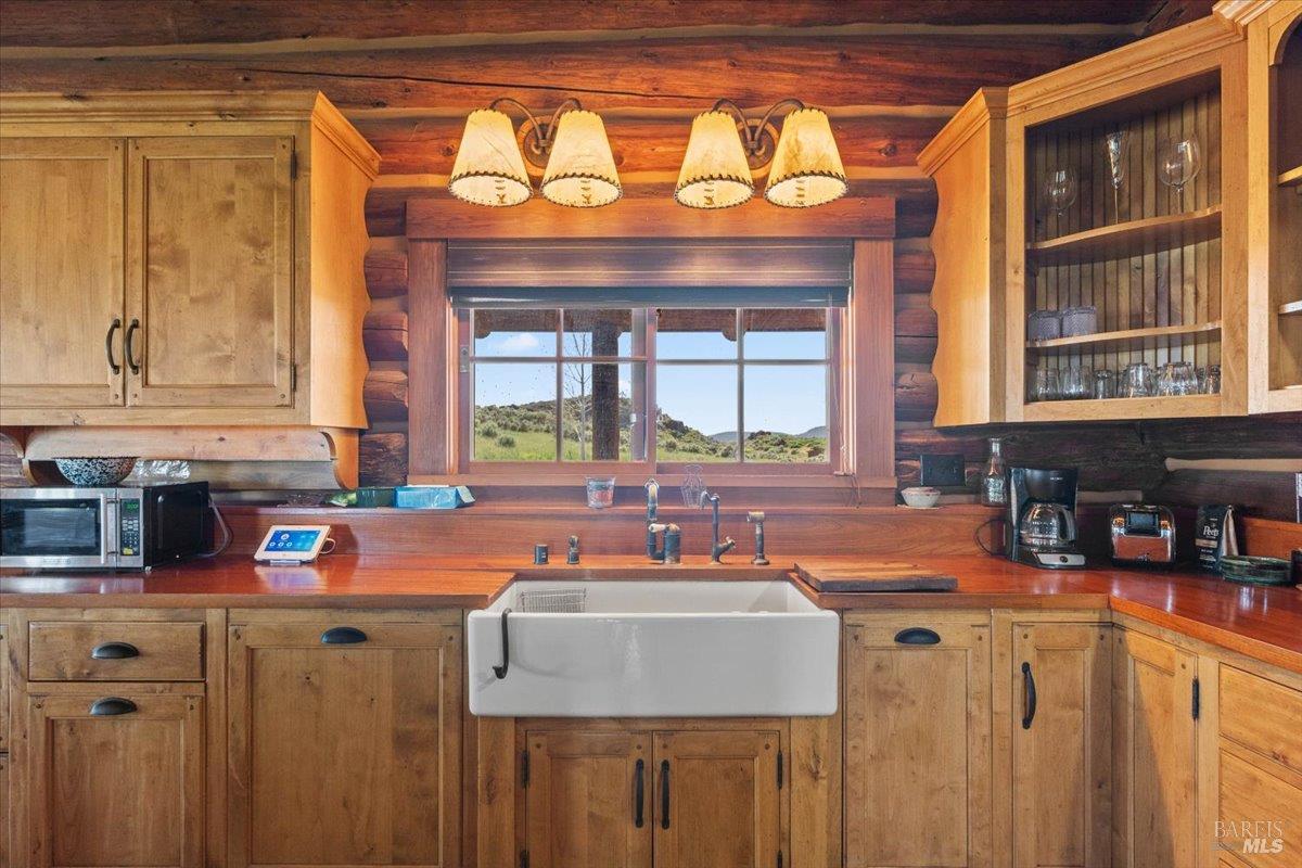 3034 State Line Road Klamath Falls, CA 97603 - Photo 21 of 42 a kitchen with a sink a counter top space and cabinets