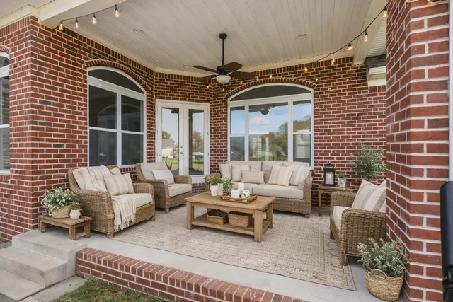 a view of a house with a yard and potted plants