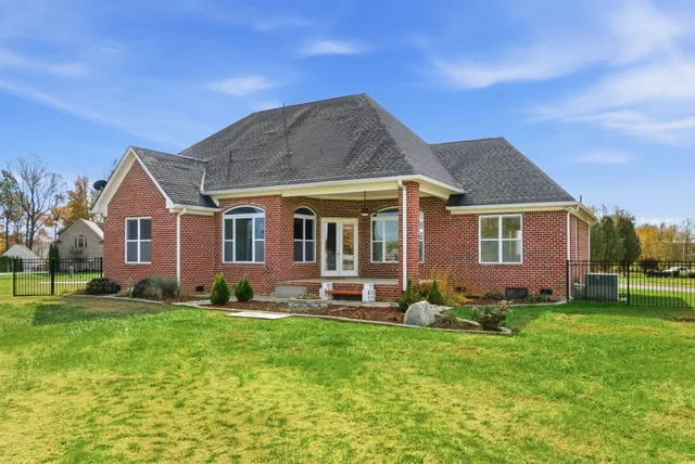 an aerial view of a house with a big yard