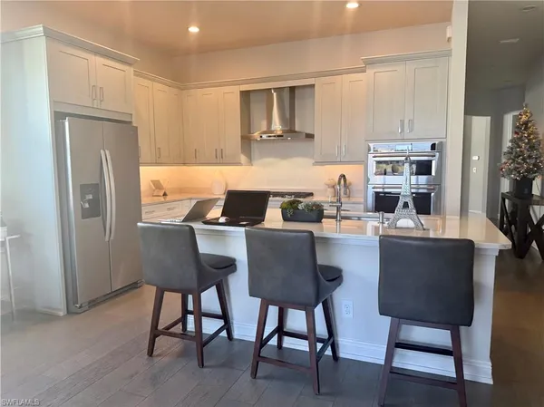 a kitchen with a table chairs refrigerator and cabinets